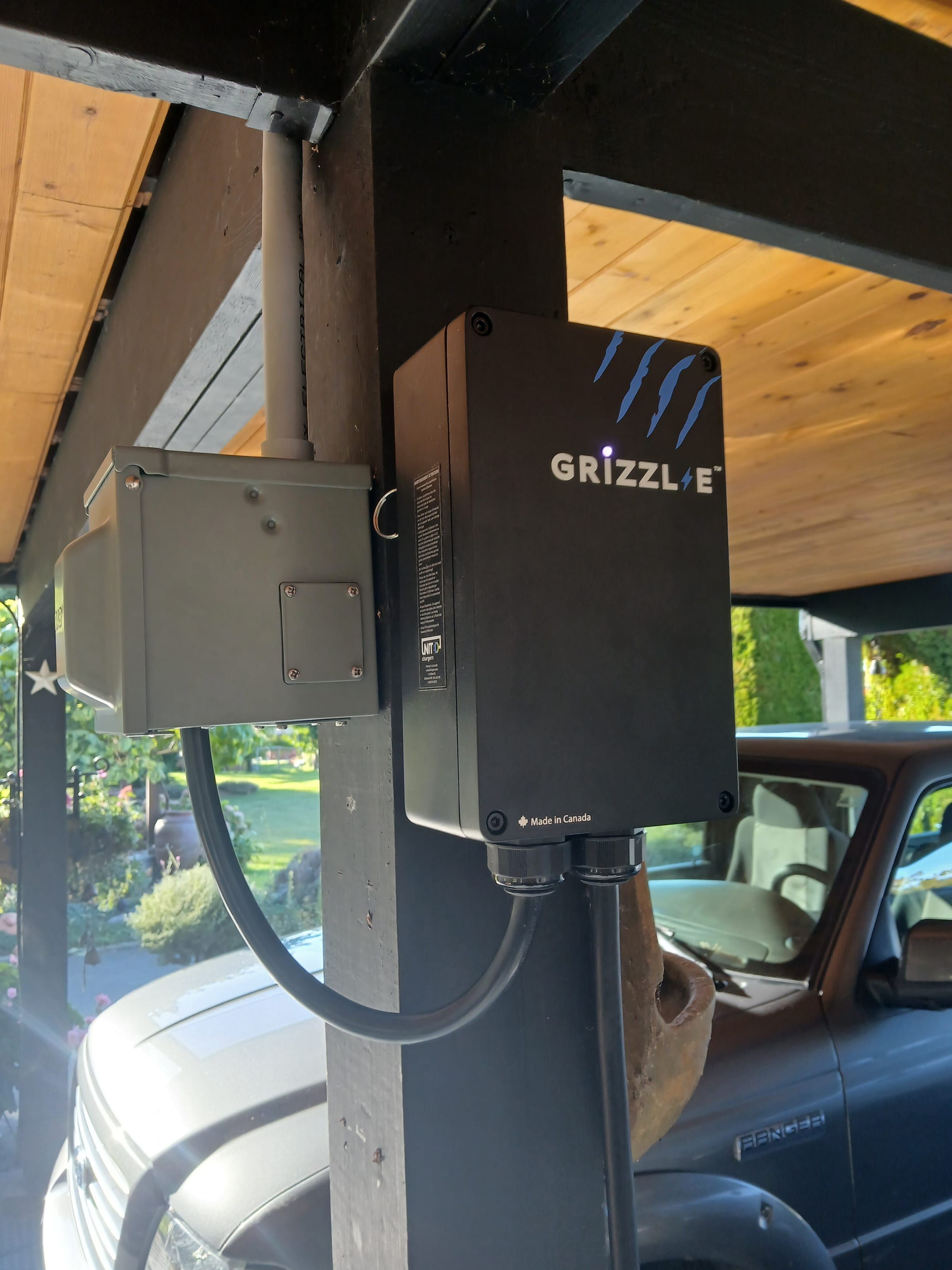 Grizzl-E Classic charger mounted on a wooden carport post.